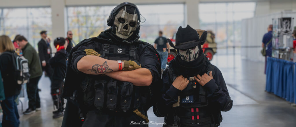 "Two cosplayers dressed as Ghost from Call of Duty standing side by side, wearing tactical skull masks and military-style gear, creating an intimidating presence in an urban environment."